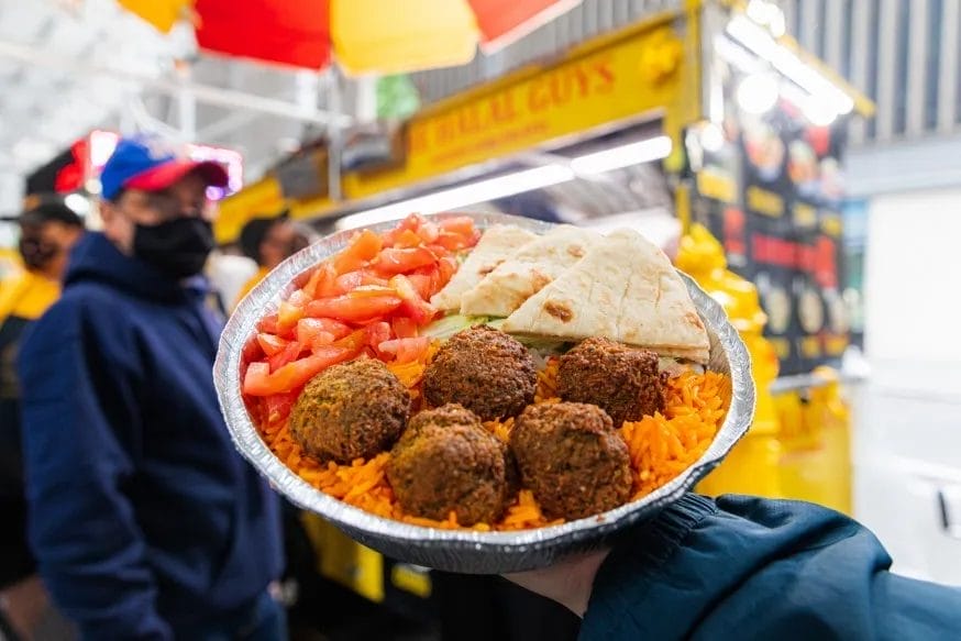 Falafals over rice with pita and vegetables from Halal Guys | New York