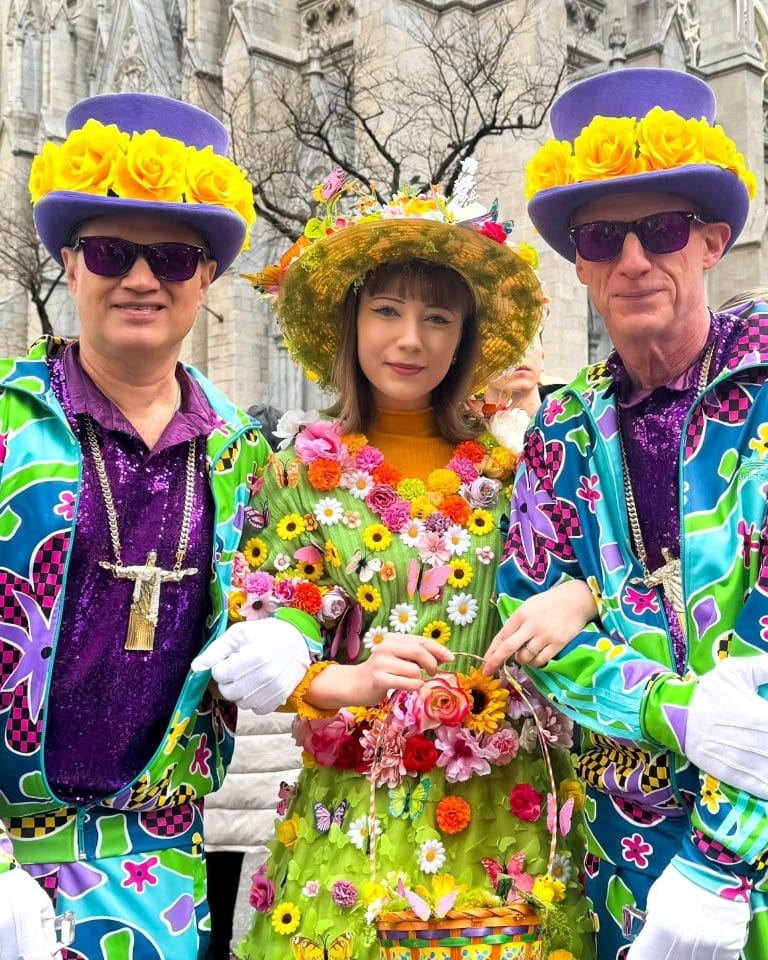 People dressed in colorful, festive outfits adorned with flowers and accessories at the Easter Parade and Bonnet Festival in New York City, one of the many attractions open on Easter Sunday.