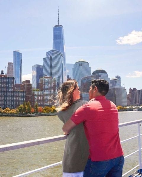A couple hugging each other on the ferry to Liberty Island