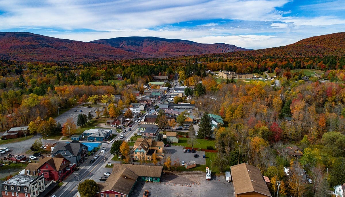 Aerial view of Tannersville, NY, showcasing a charming small town surrounded by vibrant fall foliage. Cool small towns in New York.