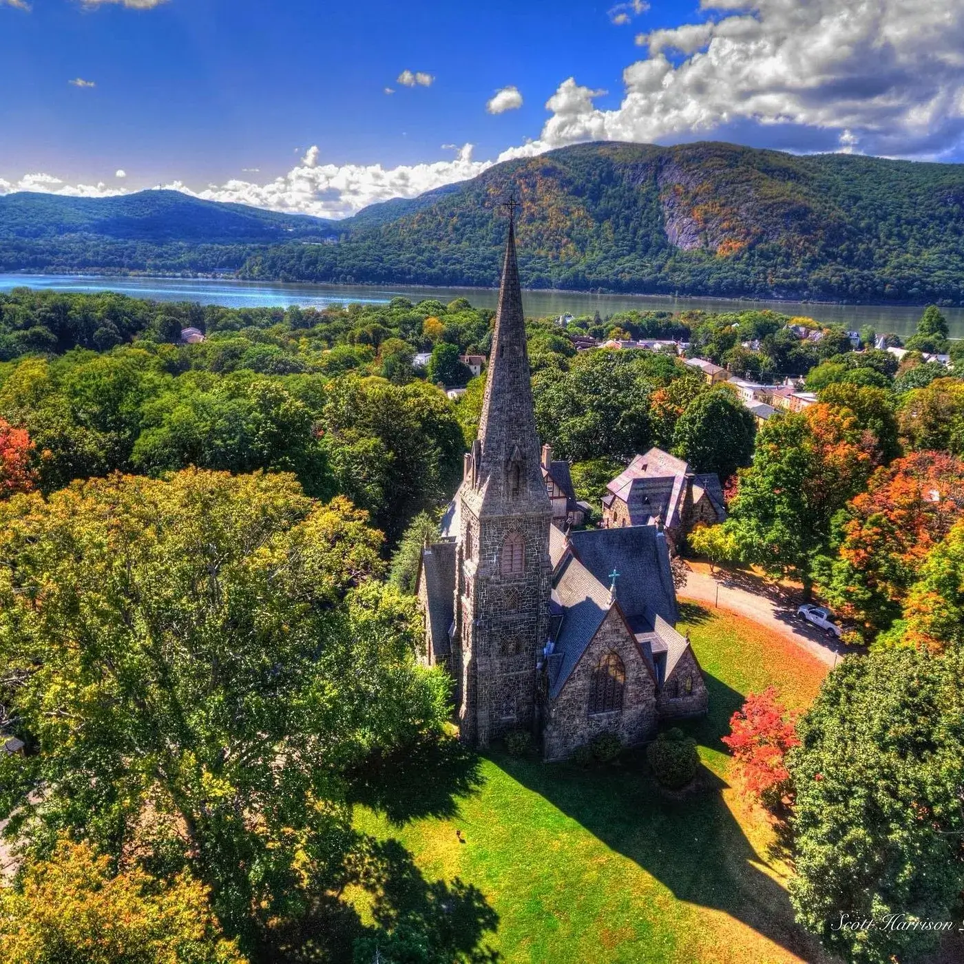 Aerial view of a church in Beacon, New York, surrounded by vibrant fall foliage and colorful autumn trees.